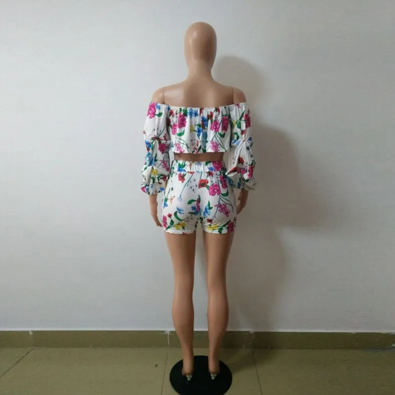 Women's multicolour printed tracksuit set with fleece sleeves on the top and matching shorts.