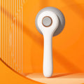 Blue and white self-cleaning pet grooming brush with massage nodules for cats and dogs