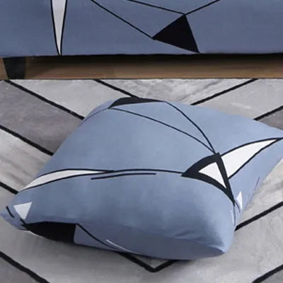 Geometric pattern stretch sofa slipcover and matching cushion cover on a double seat sofa.