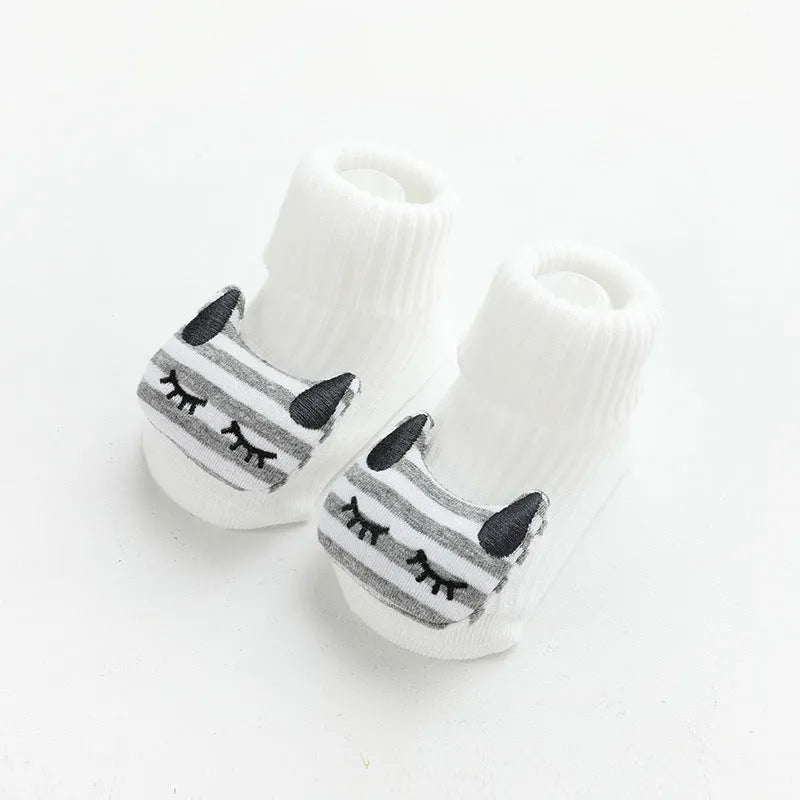 Baby socks with anti-slip glue dots on soles in combed cotton, showing mid-tube height and various colour options