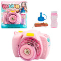 Yellow automatic camera-shaped bubble machine for children on a green lawn, producing soap bubbles.