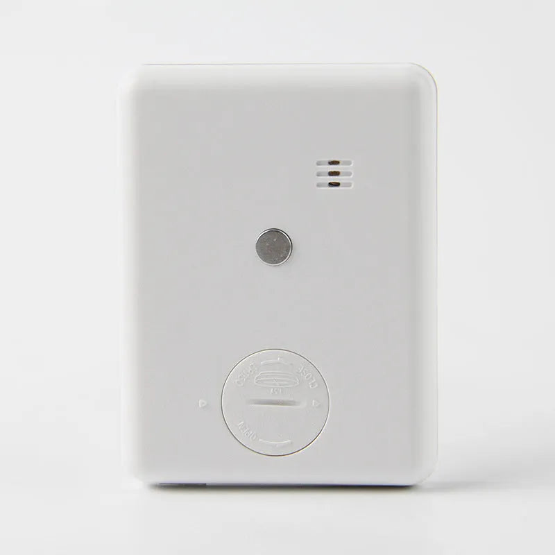 Black and white digital kitchen timer with magnetic back showing countdown display