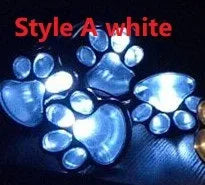 Black solar powered animal paw print garden lights with four paw shapes connected to solar panel
