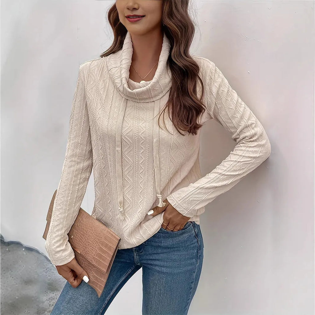 Apricot coloured long sleeve hooded pullover sweater on a hanger, showing the drawstring and solid colour.