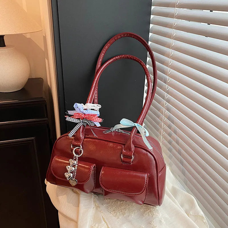 Retro brown PU leather women's pillow-shaped handbag with double shoulder strap and flap closure.