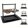 Black iron elevated dog feeding stand holding three different sized bowls for large breeds.