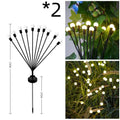 Solar-powered LED garden light with multiple heads on stainless steel ground spikes