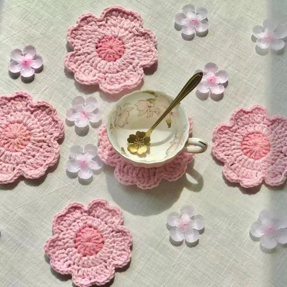 Hand-woven wool coaster in natural colour protecting wooden table from drink