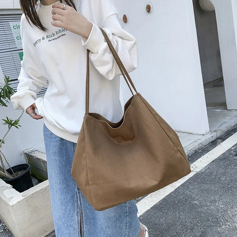 Solid colour women's canvas handbag with double shoulder straps and large shopping capacity