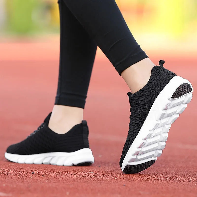 Women's running shoes with fly weaving upper in black, pink, or white colours showing wear-resistant outsole
