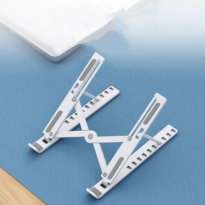 Black folding desktop bracket adjusted to a medium height angle on a wooden desk.