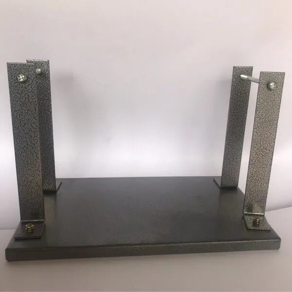 Black iron portable electric planer flip chip bracket accessory on a workbench.