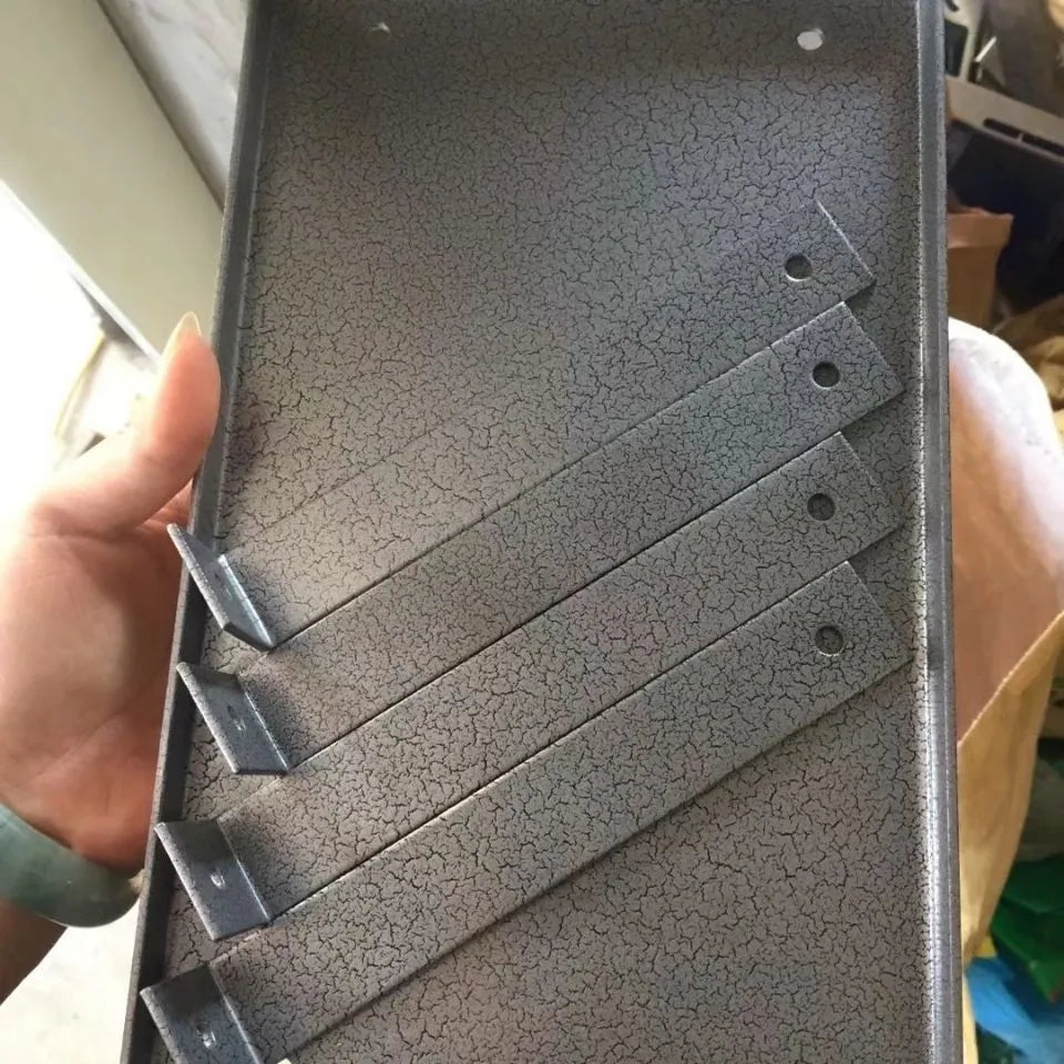 Black iron portable electric planer flip chip bracket accessory on a workbench.