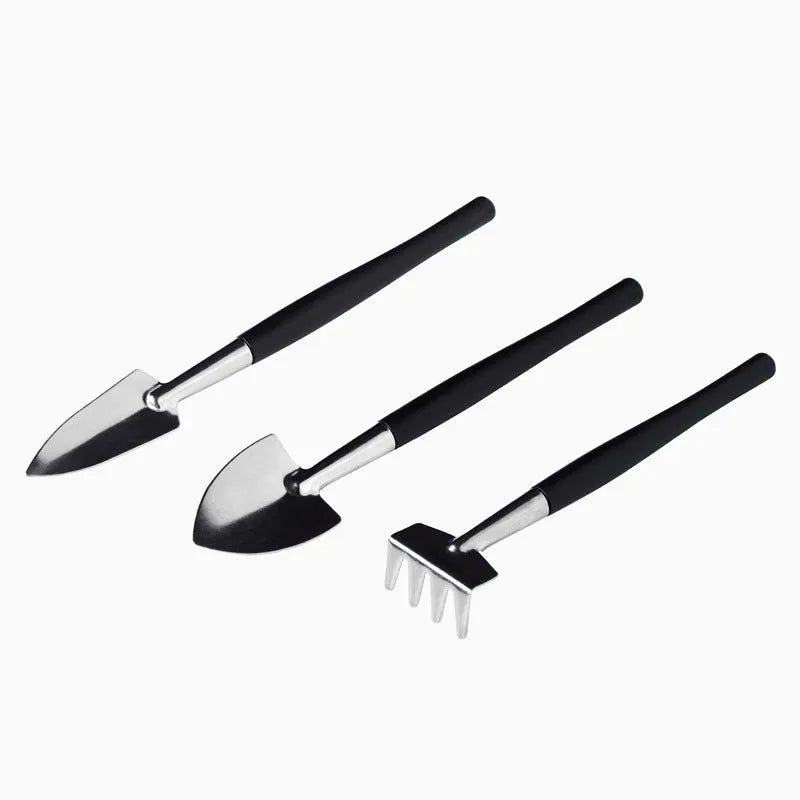 Black plastic and metal succulent gardening tool set with 16 pieces including scissors, shovel, watering bottle, and cushion.