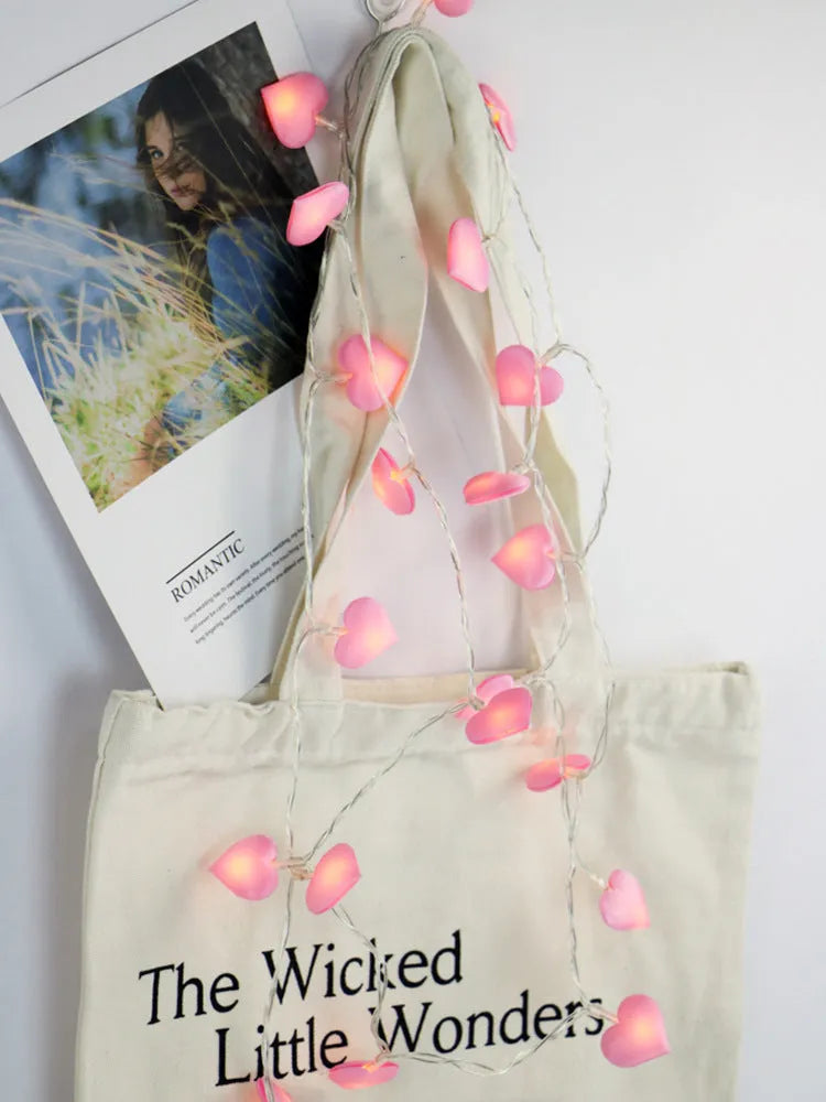 Pink and purple heart-shaped LED fairy lights hanging decoratively with 3-metre cable length
