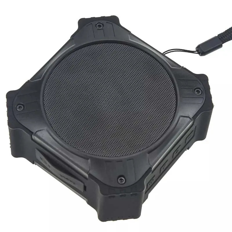 Black waterproof Bluetooth speaker showing compact cube design with control buttons and wrist strap attachment