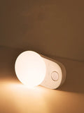 White Baseus rechargeable motion sensor LED night light for bedside or hallway use.