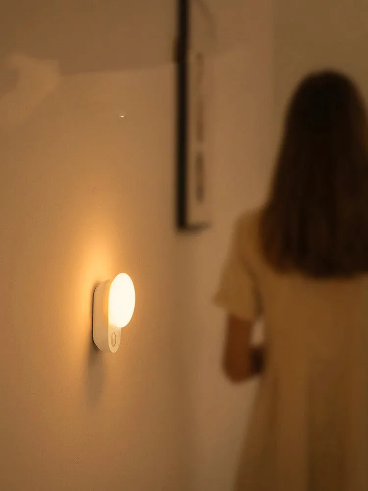 White Baseus rechargeable motion sensor LED night light for bedside or hallway use.