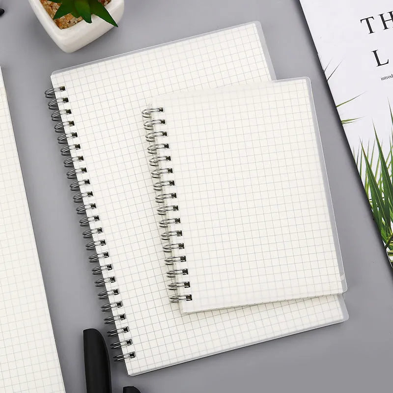 Creative coil notebook open showing grid pages, available in A5, B5, and A6 sizes