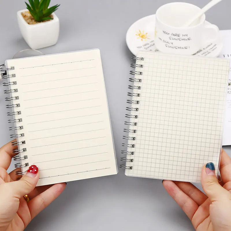 Creative coil notebook open showing grid pages, available in A5, B5, and A6 sizes
