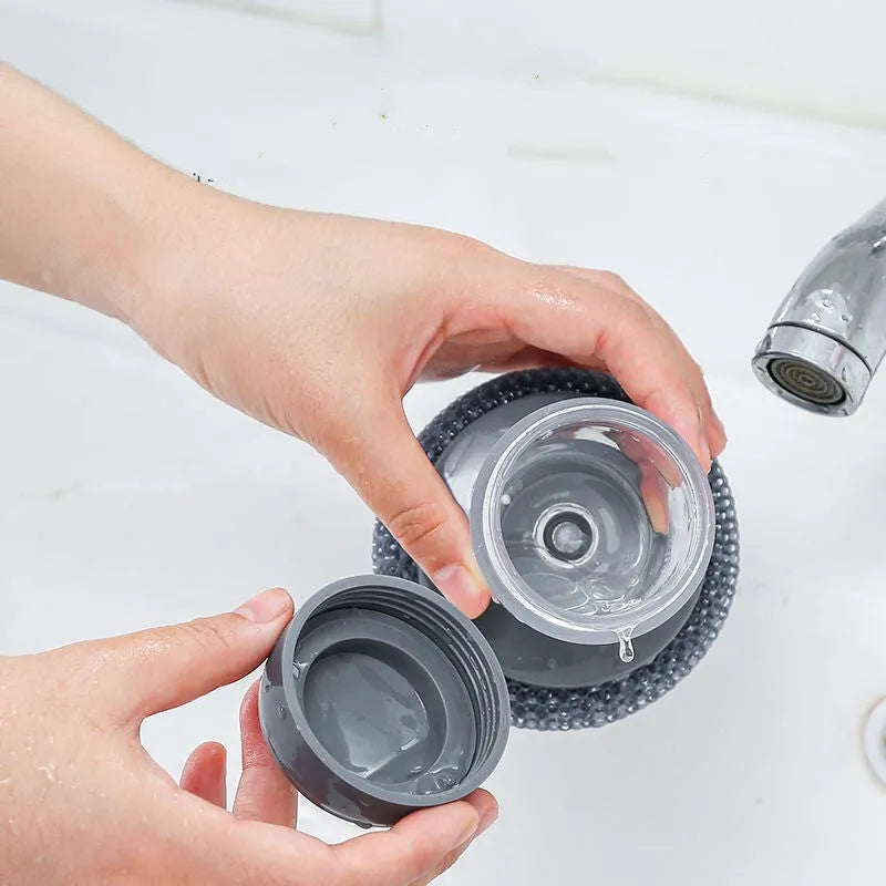 Kitchen palm brush with integrated push-type soap dispenser and bristles for scrubbing.