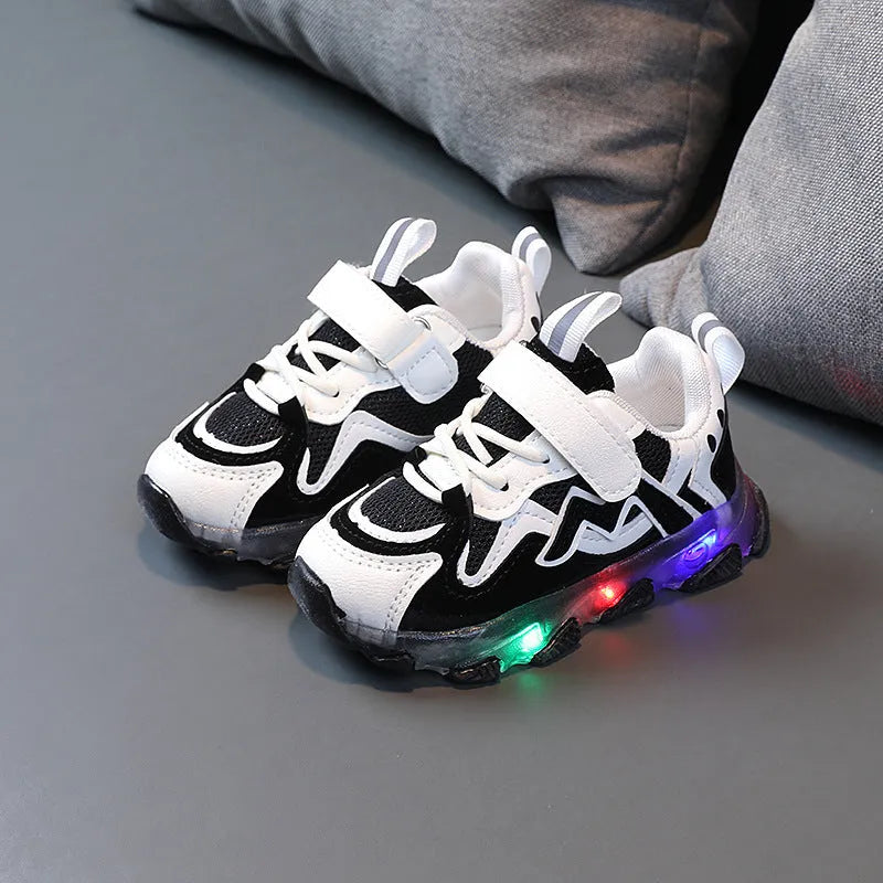 Kids black mesh velcro sneakers with a bright light on the sole, shown on a size chart.