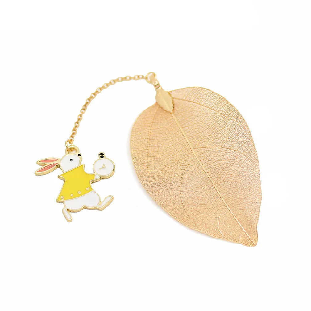 Three decorative alloy bookmarks featuring Alice, rabbit and clock designs on a leaf-shaped base