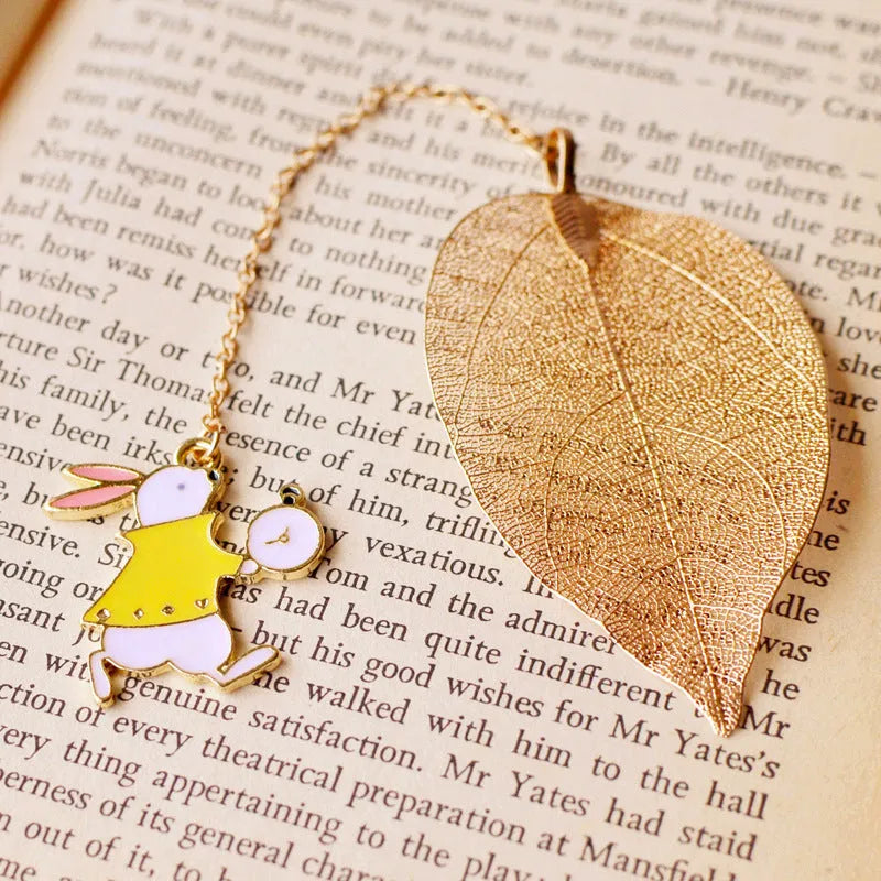 Three decorative alloy bookmarks featuring Alice, rabbit and clock designs on a leaf-shaped base