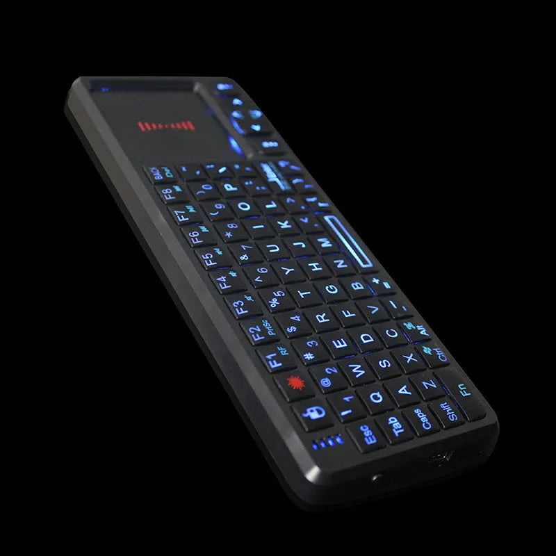 Compact black wireless mini keyboard with touch screen and matching mouse on a desk.