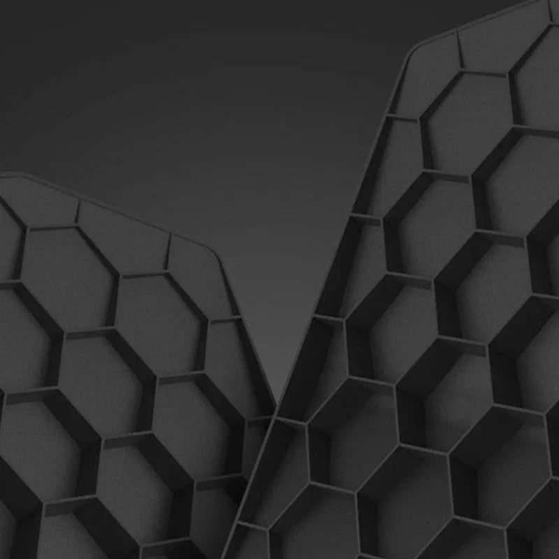 Creative black three-dimensional geometric mouse pad with honeycomb support structure on a desk