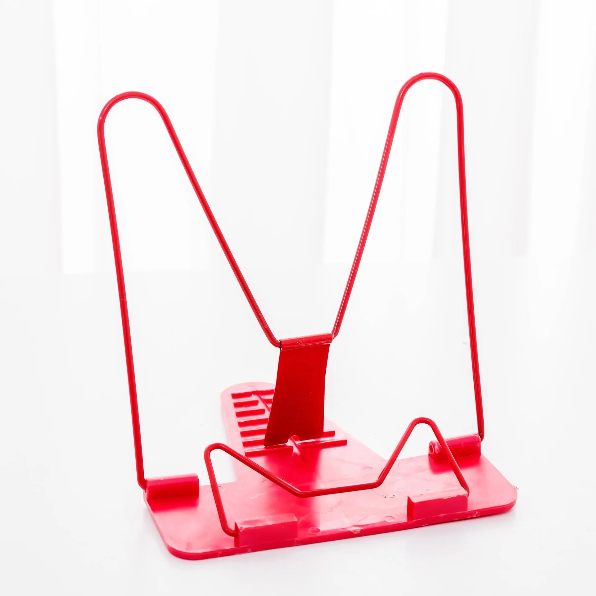 Red, green, and blue multifunctional reading frame made of metal and plastic on a desk