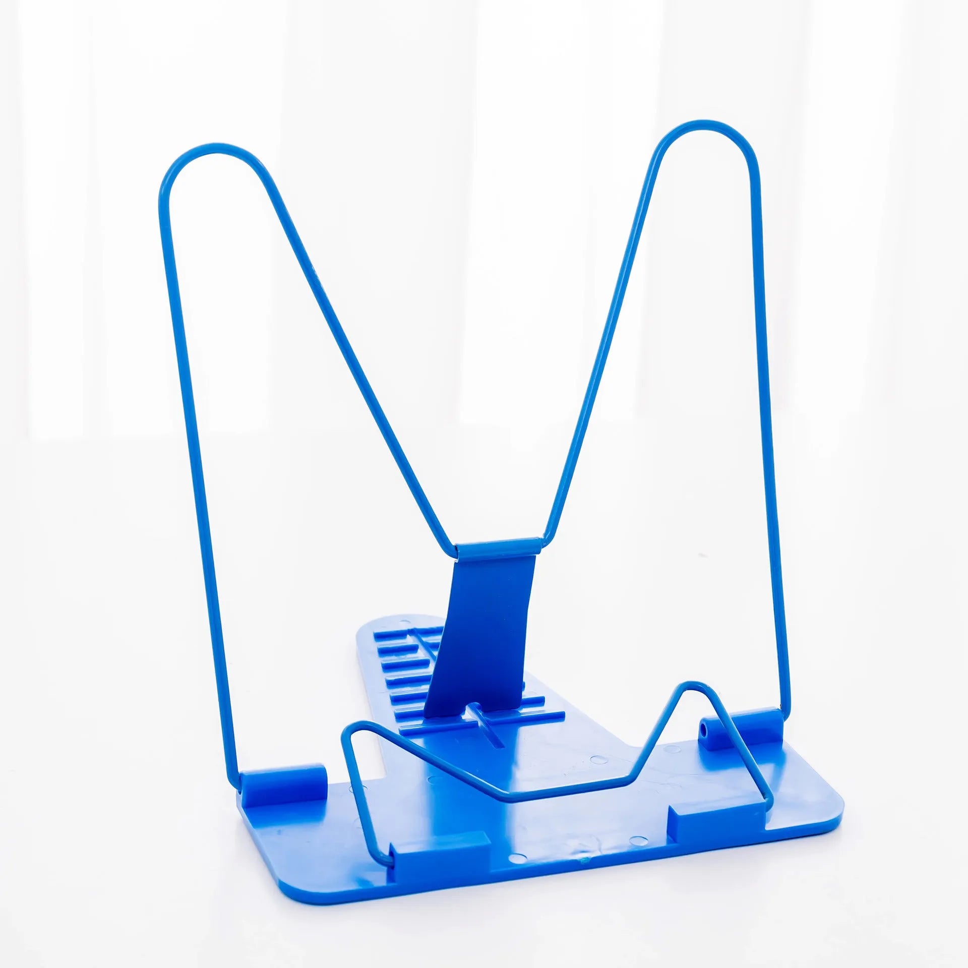 Red, green, and blue multifunctional reading frame made of metal and plastic on a desk