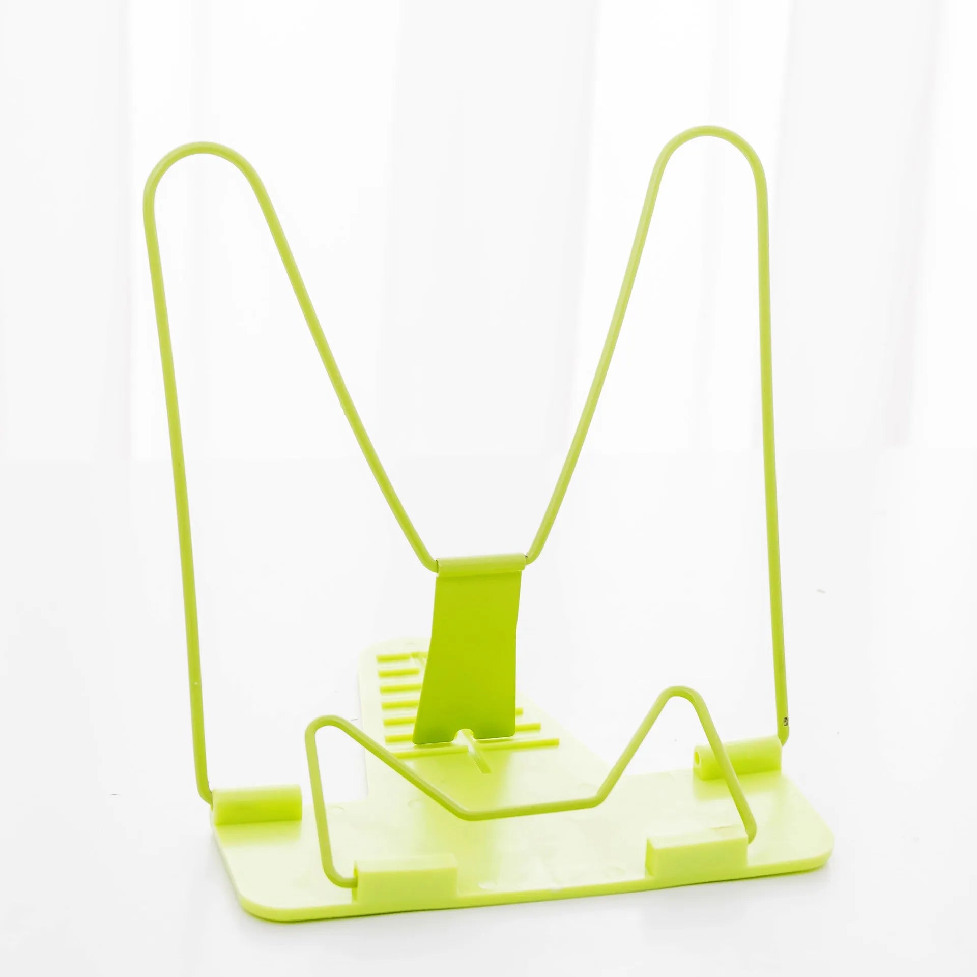 Red, green, and blue multifunctional reading frame made of metal and plastic on a desk