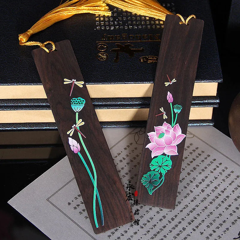 Chinese-style sandalwood bookmark with painted lotus floral design and polished finish