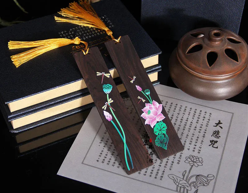 Chinese-style sandalwood bookmark with painted lotus floral design and polished finish