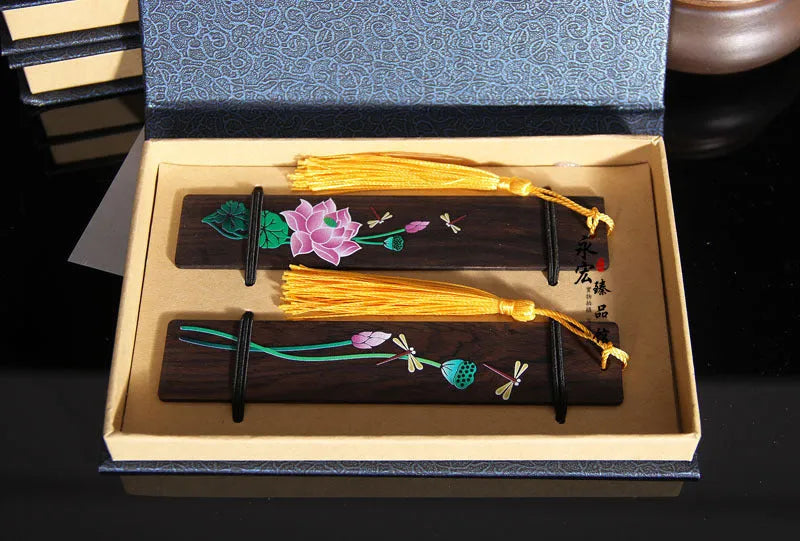 Chinese-style sandalwood bookmark with painted lotus floral design and polished finish