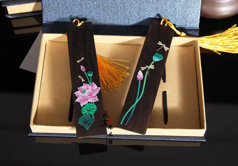 Chinese-style sandalwood bookmark with painted lotus floral design and polished finish
