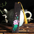 Chinese-style sandalwood bookmark with painted lotus floral design and polished finish