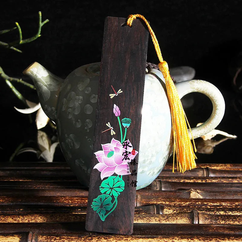 Chinese-style sandalwood bookmark with painted lotus floral design and polished finish