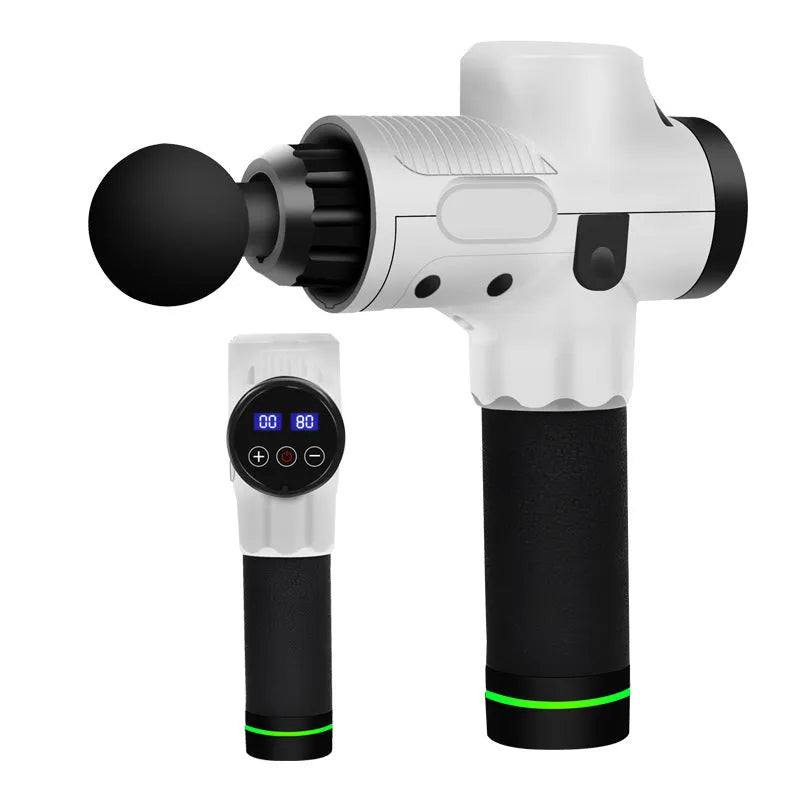 Black electric muscle massage gun with multiple interchangeable heads on a table.