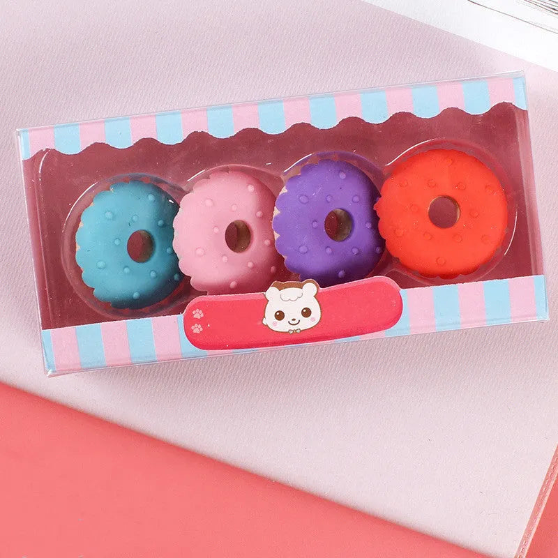 Set of 12 cartoon-shaped erasers including cones, ice creams, donuts, and lollipops for children.