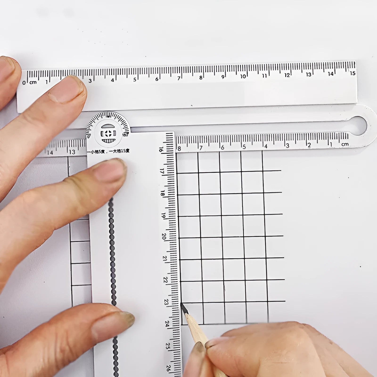 White 30 cm plastic multi-function angle and straight edge ruler.