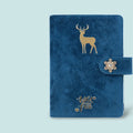 A6 loose-leaf notebook with a textured cloth cover, shown in a blue velvet colour variant, open to reveal binder rings.