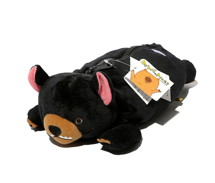 Brown plush pencil case with cartoon wombat design and a silver zipper, open to show interior.