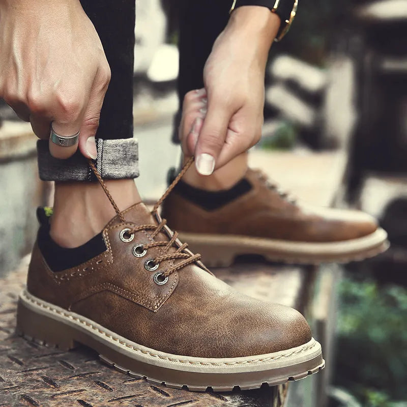 Men's black casual tooling shoes with a round toe and lace-up front on a rubber sole.