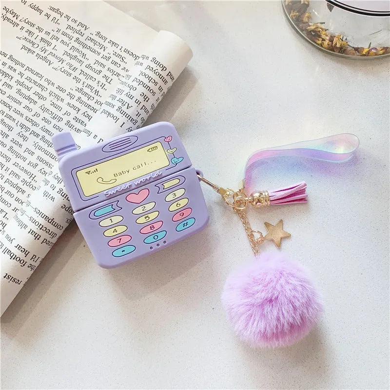 Purple silicone clamshell case for Apple AirPods with a small white fur ball pendant attached.