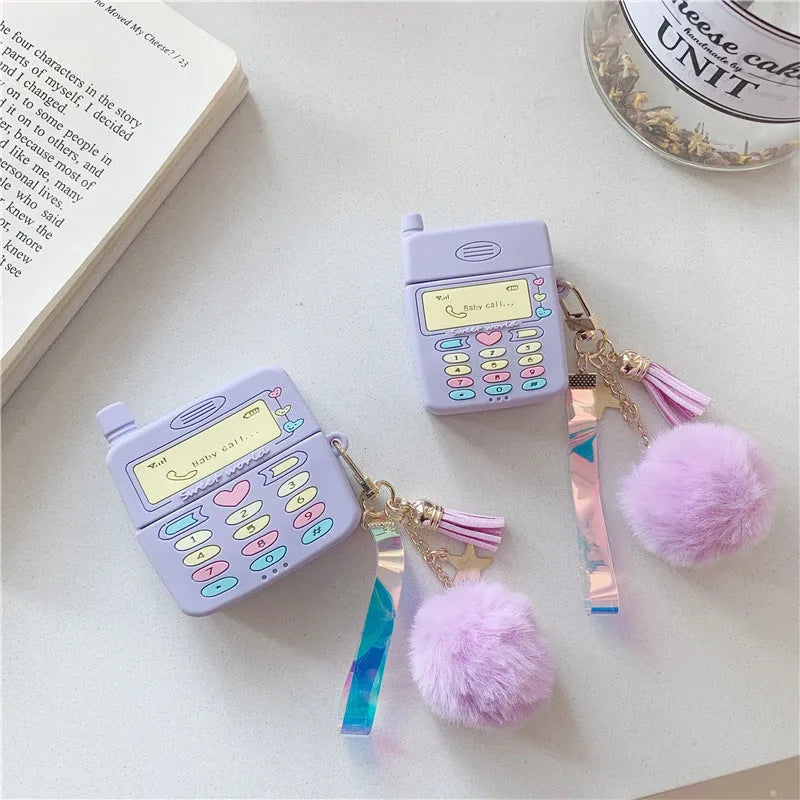 Purple silicone clamshell case for Apple AirPods with a small white fur ball pendant attached.
