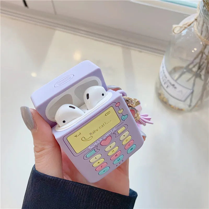 Purple silicone clamshell case for Apple AirPods with a small white fur ball pendant attached.
