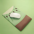 Soft thickened wrist mouse pad with colourful graphic print on fabric and a grey silicone non-slip base.