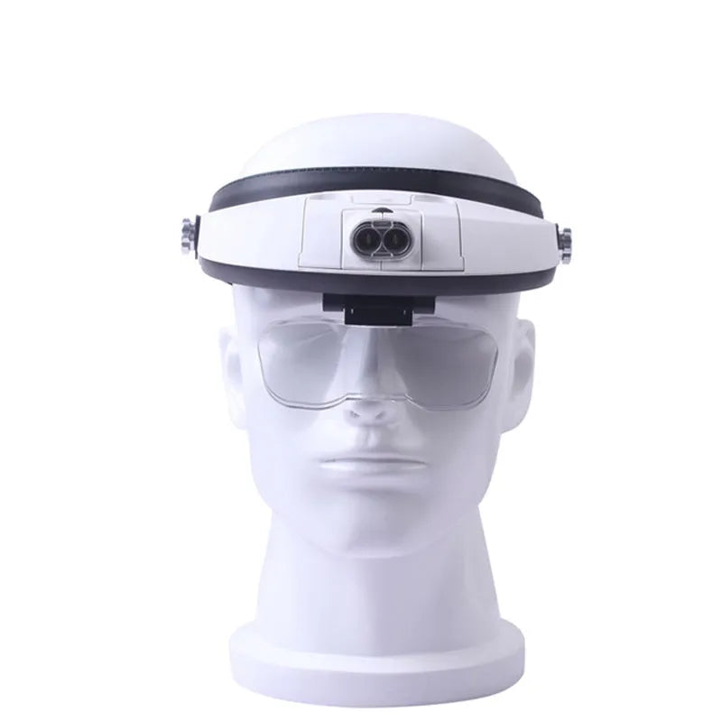 A person wearing a black LED headband magnifier with five acrylic lenses, using it for detailed hands-on repair work.